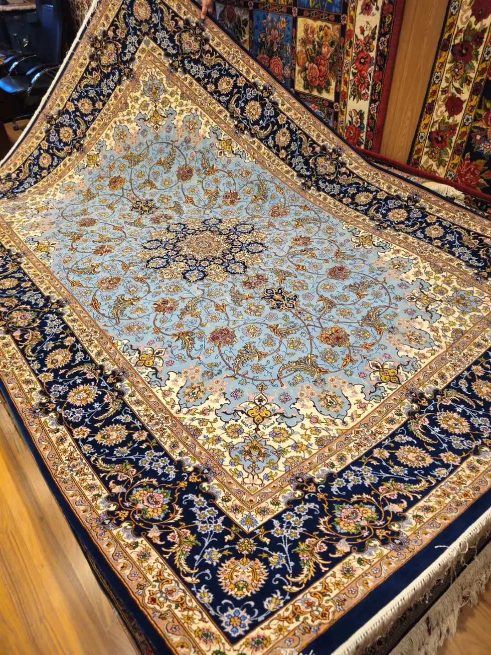 Pale blue Isfahan wool and silk carpet PRR-HM-004 showing dark navy floral border and central medallion