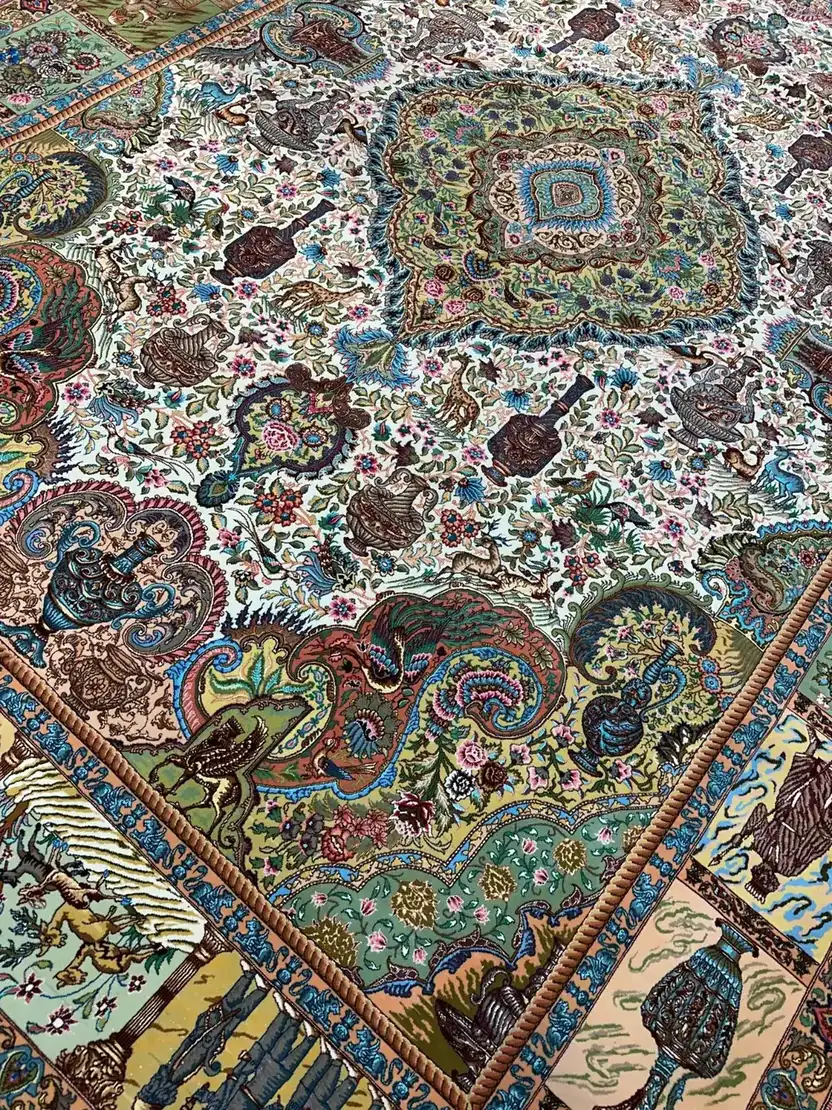 Angled view of floral field and pictorial border on Tabriz carpet PRR-HM-010