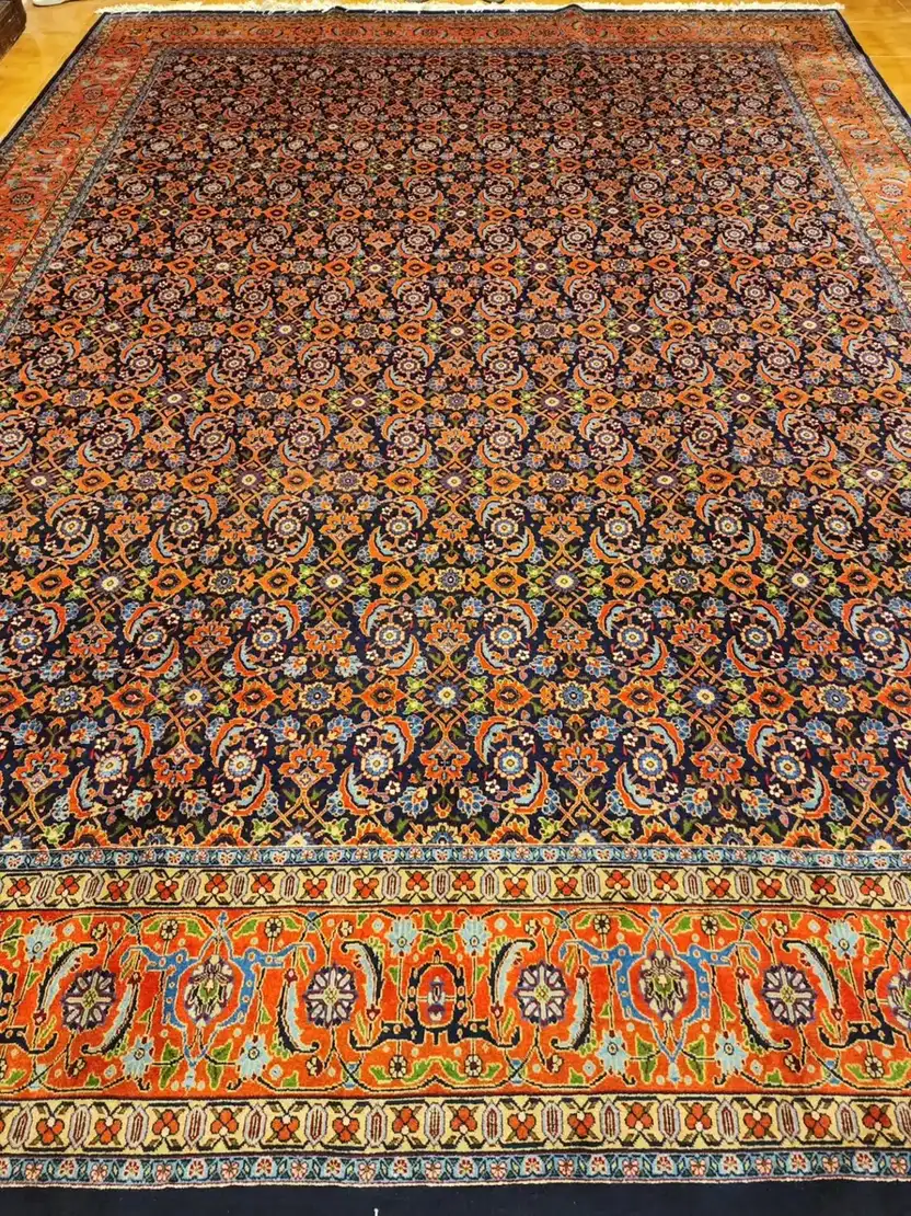Full view of large dark blue Tabriz Mahi rug PRR-HM-012 with rust orange border
