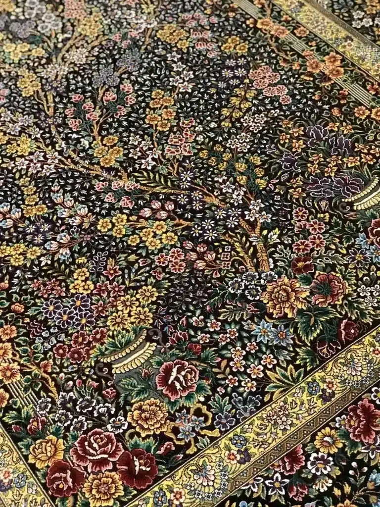 Midnight Blossom Canopy handmade Qom pure silk carpet featuring a dense flowering canopy of roses, blossoms and branching vines rendered against a luminous black silk field